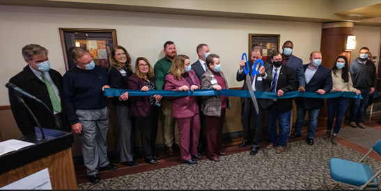 A group of people doing a ribbon cutting