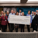 Group of people with a giant check donation